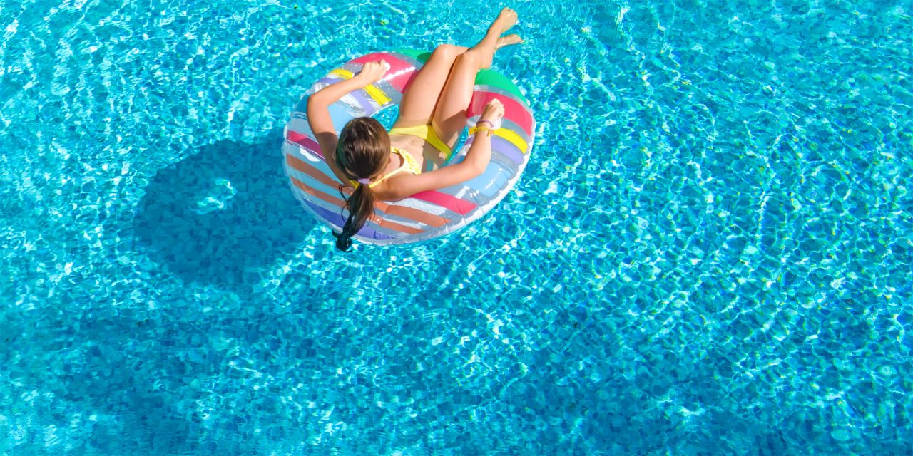Girl in Hotel Pool; Courtesy of JaySi/Shutterstock.com