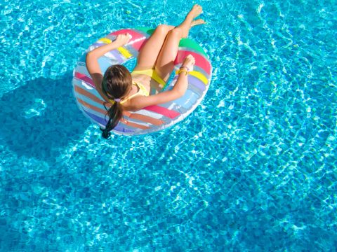 Girl in Hotel Pool; Courtesy of JaySi/Shutterstock.com