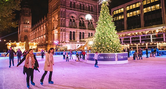 People ice skating at the National History Museum in London