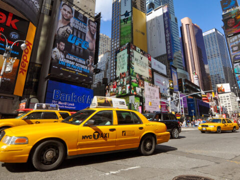 Times Square and yellow cabs wide angle photo in summer, New York City; Courtesy of Wangkun Jia/Shutterstock