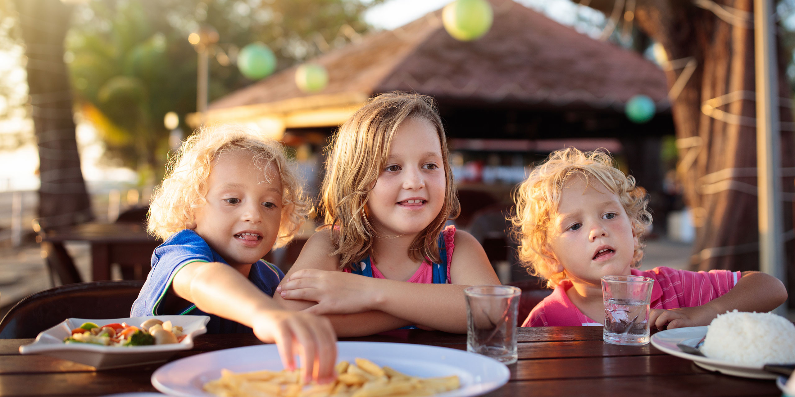 Kids Eating at Resort; Courtesy of FamVeld/Shutterstock.com