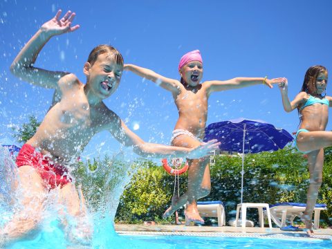 Kids Jumping in Pool; Courtesy of Pavel L Photo and Video/Shutterstock.com