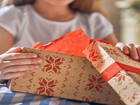 Kid with Holiday Gifts; Courtesy of Yuganov Konstantin/Shutterstock.com