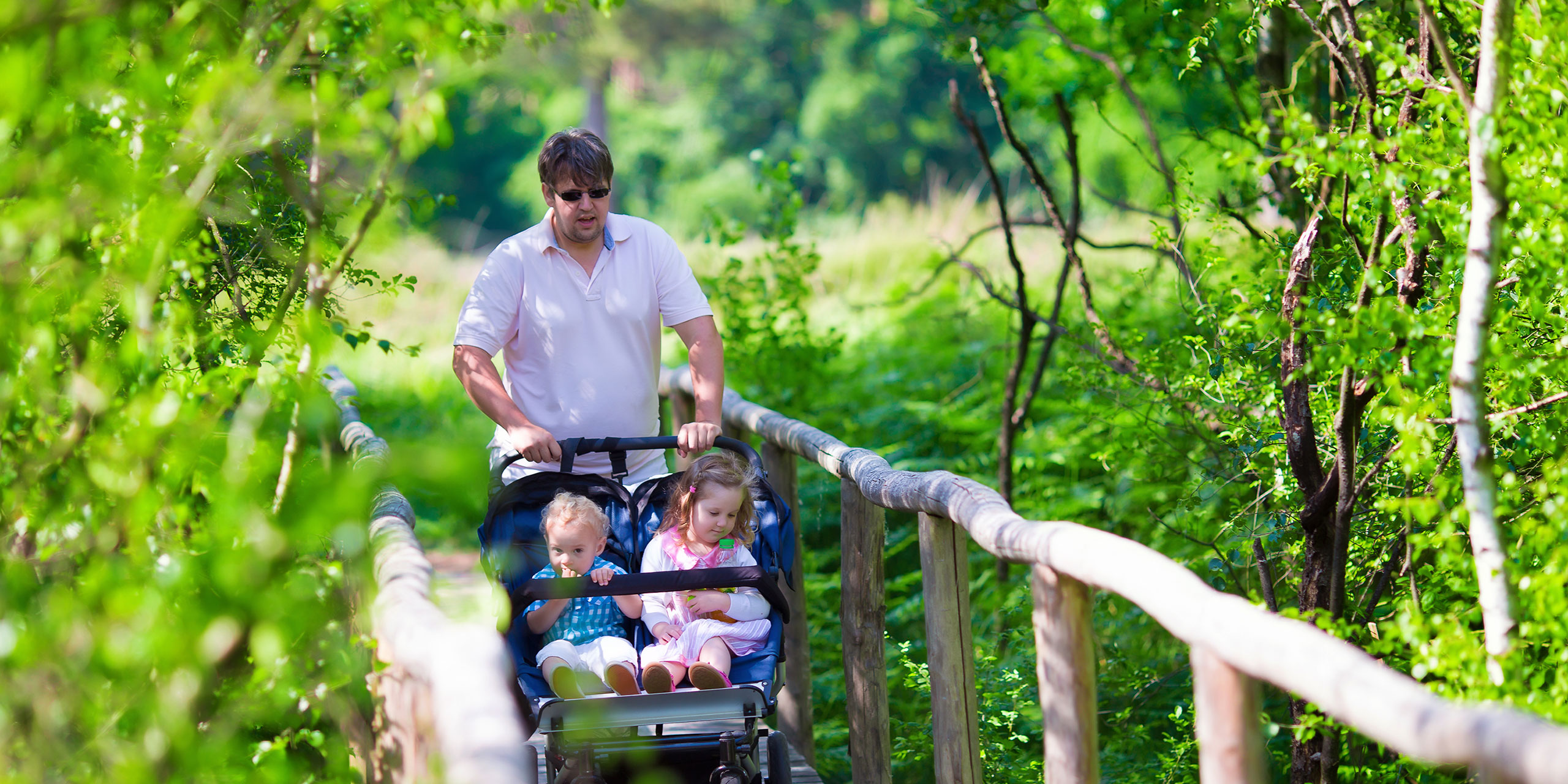 Dad with Double Stroller; Courtesy of FamVeld/Shutterstock.com
