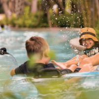 Young Boys Floating in Lazy River at Four Seasons Resort Orlando at Walt Disney World Resort; Courtesy of Four Seasons Resort Orlando at Walt Disney World Resort