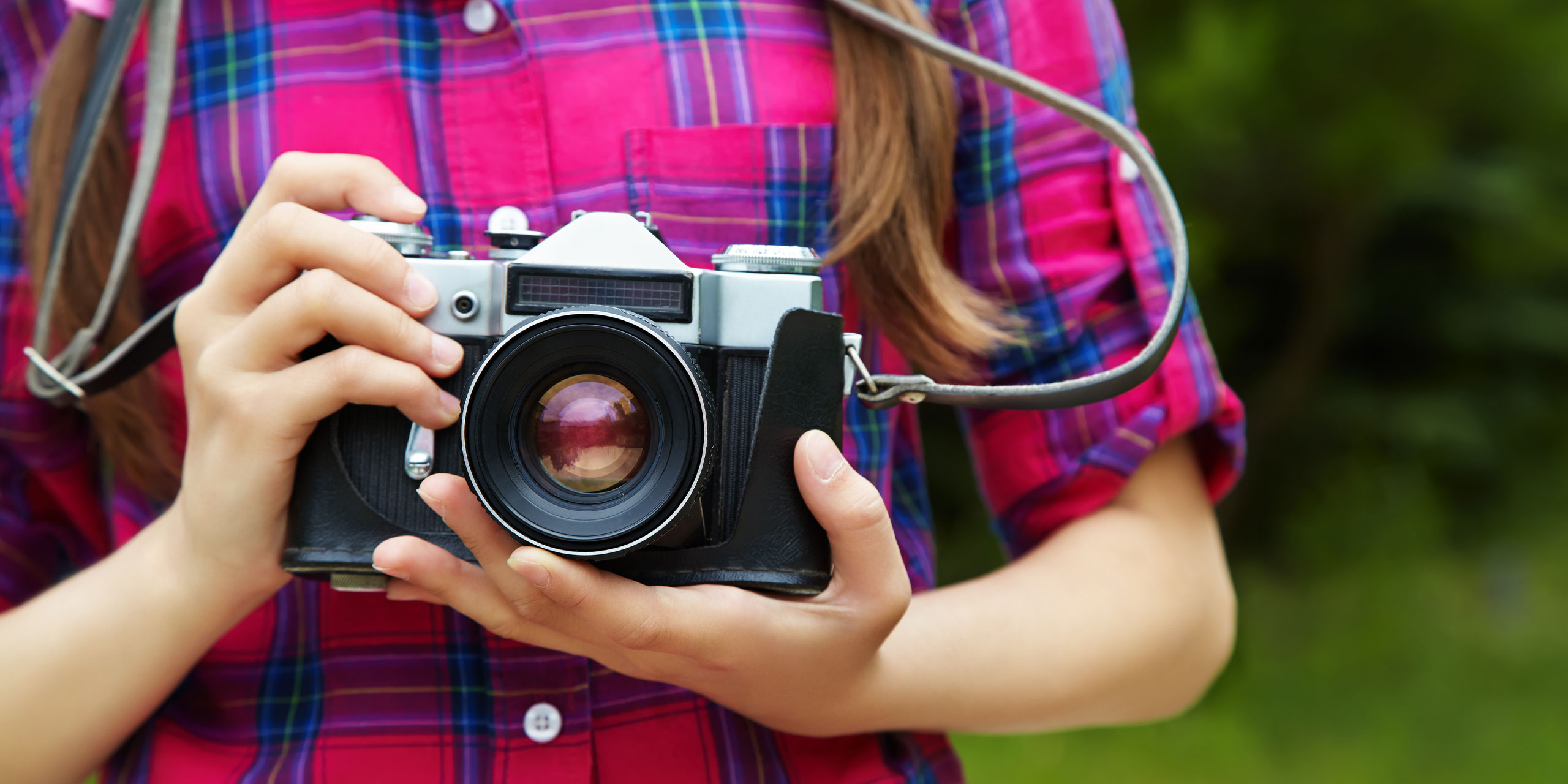 Girl with a Camera; Courtesy of Evgeny Bakharev/Shutterstock.com