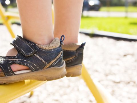 Child Wearing Sandals at Playground; Courtesy of Paul-André Belle-Isle/Shutterstock.com