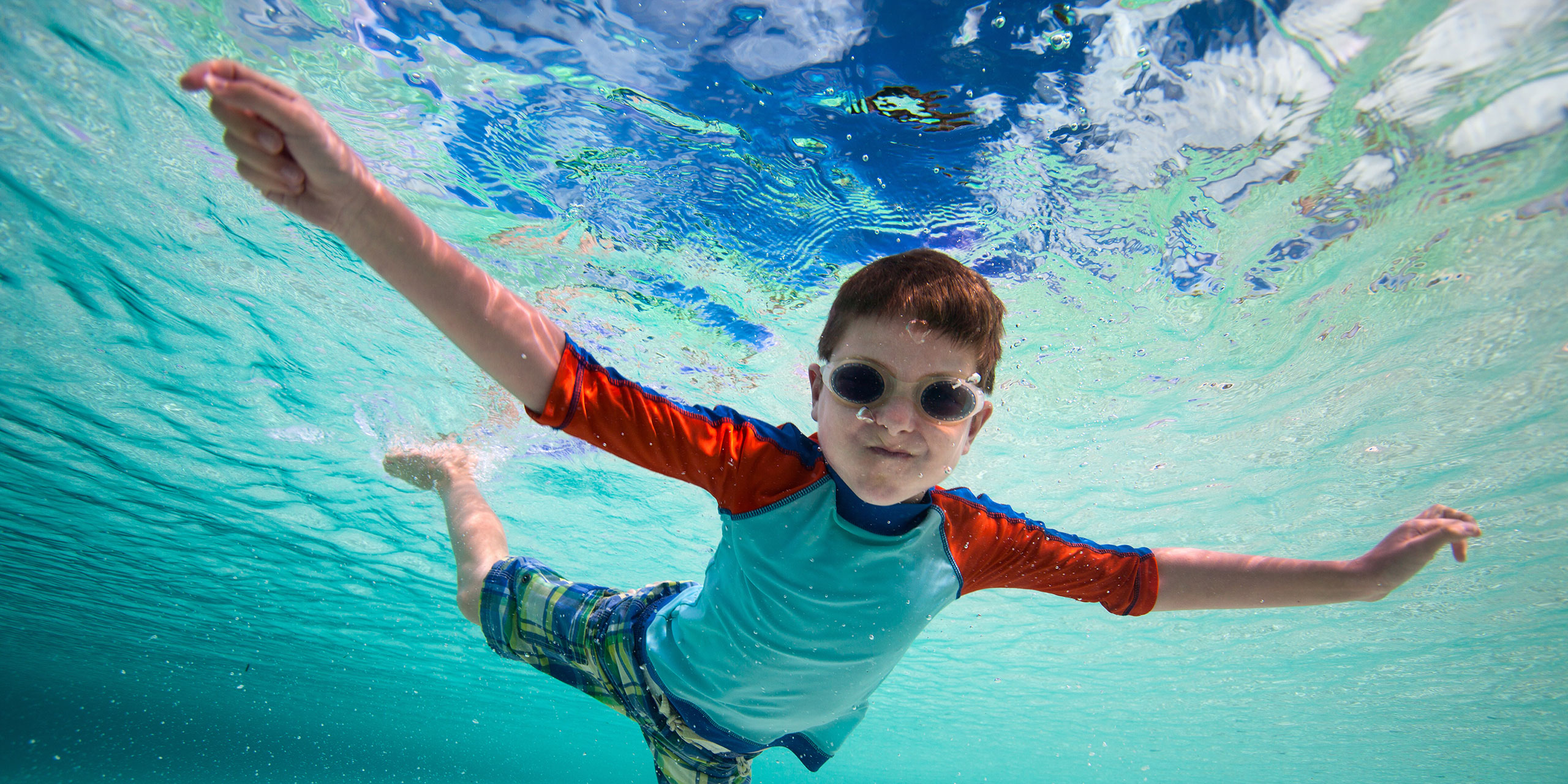 Young Boy Swimming in Caribbean; Courtesy of BlueOrange Studio/Shutterstock.com