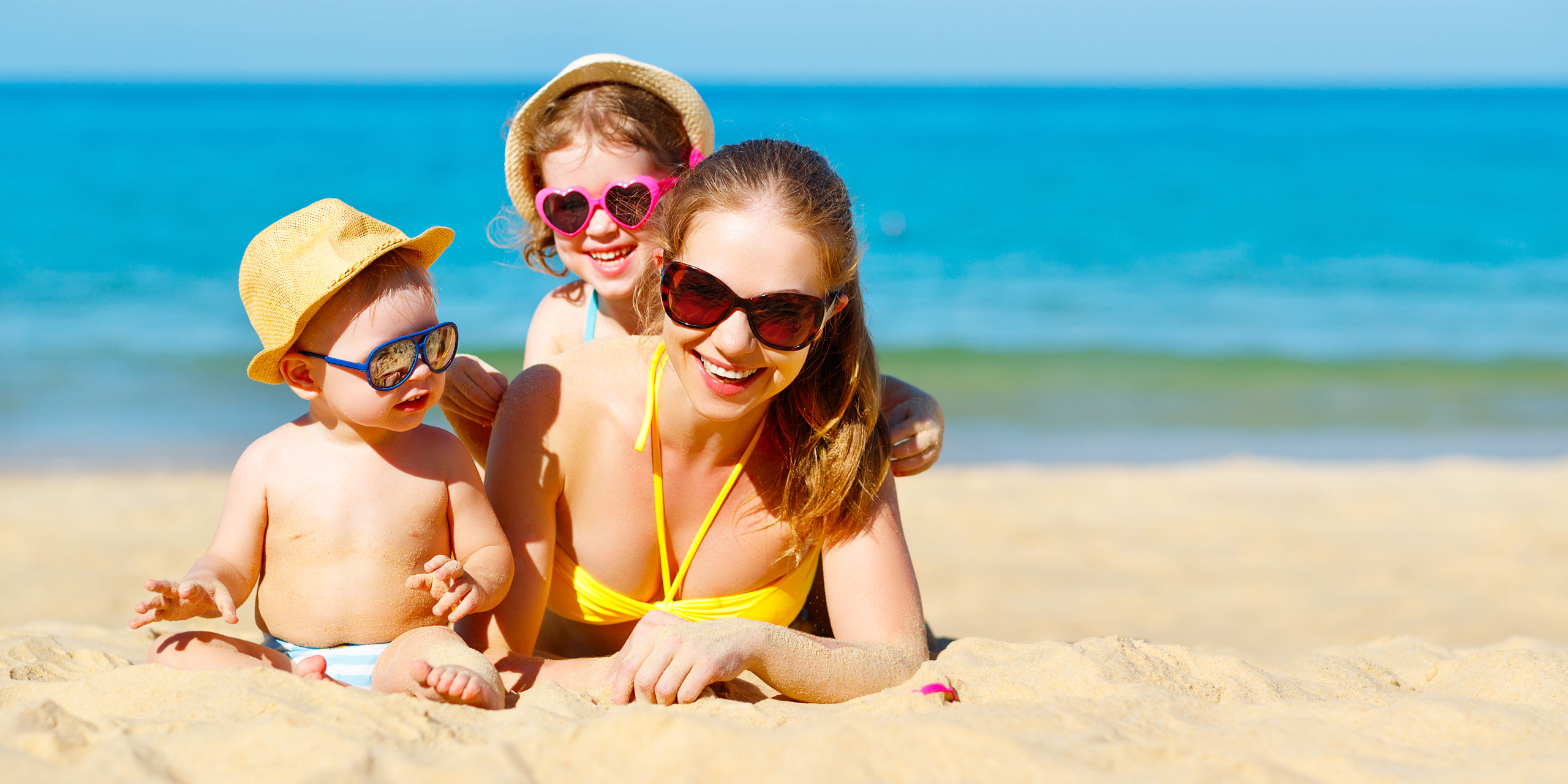 Mom and Kids on the Beach; Courtesy of Evgeny Atamanenko/Shutterstock.com