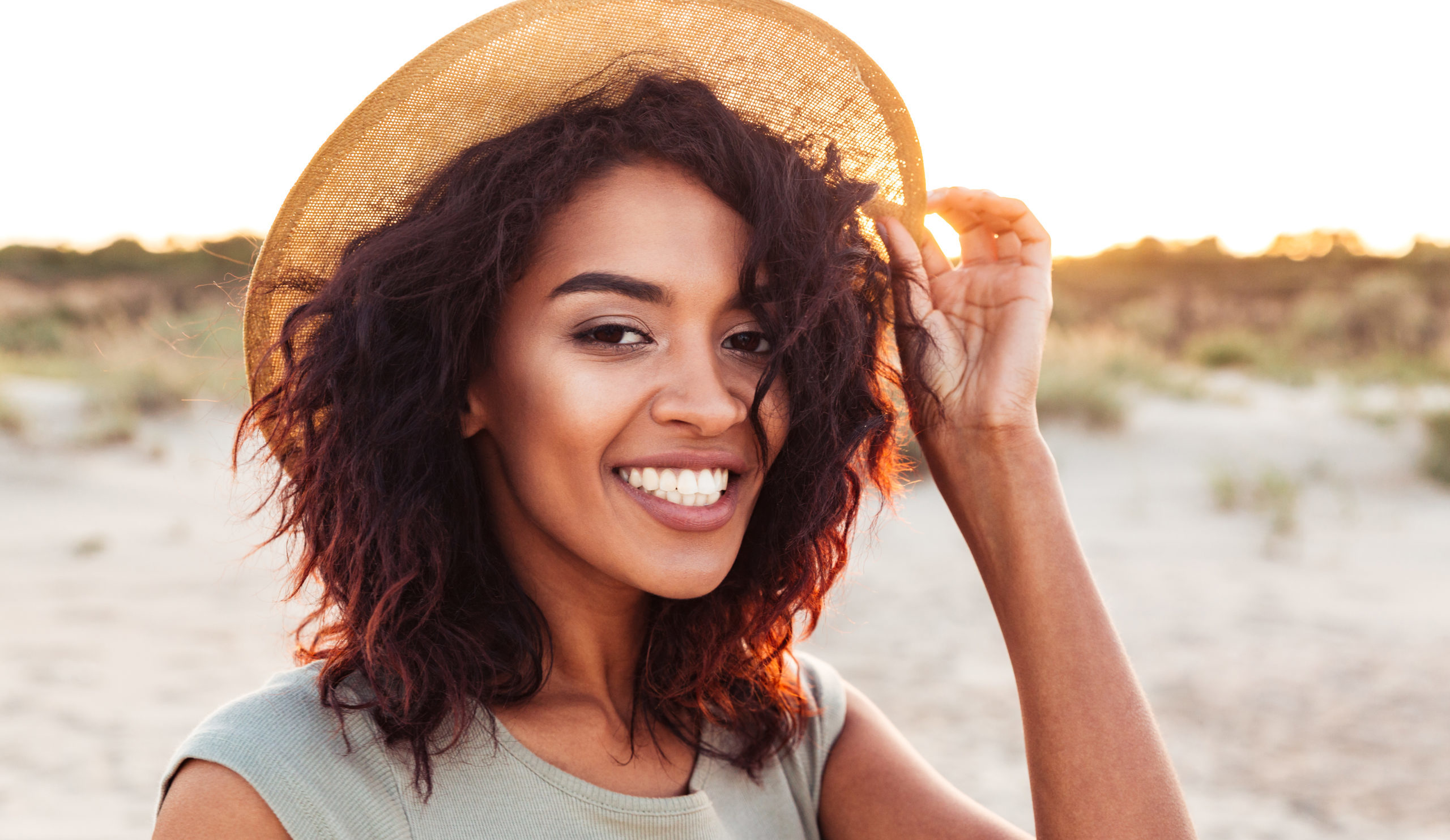 Woman smiling wearing a sun hat
