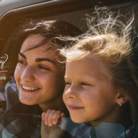 Happy family on a road trip in their car.; Courtesy of Estrada Anton/Shuttertsock
