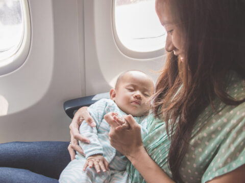 baby sleeping on plane; Courtesy of Odua Images / Shutterstock