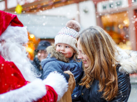 toddler mom christmas market santa; Courtesy of Romrodphoto /Shutterstock