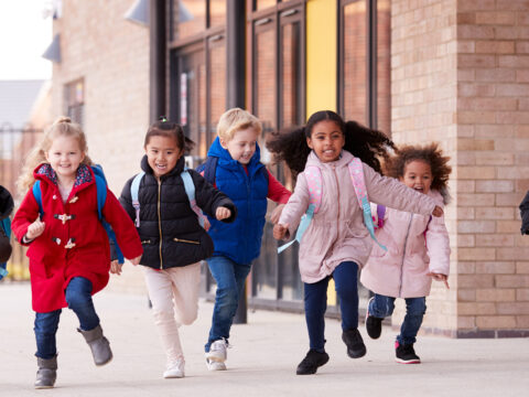 kids running wearing coats; Courtesy of Monkey Business Images /Shutterstock