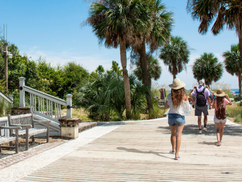 Family walking to the beach on summer vacation; Courtesy of margaret.wiktor/Shutterstock