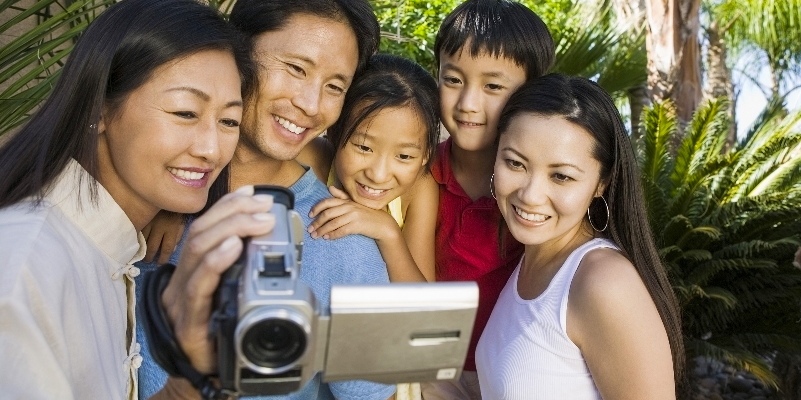 Family Looking at Video Camera Screen; Courtesy of sirtravelalot/Shutterstock