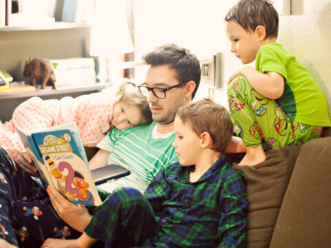 Dad Reading Bedtime Stories to Kids