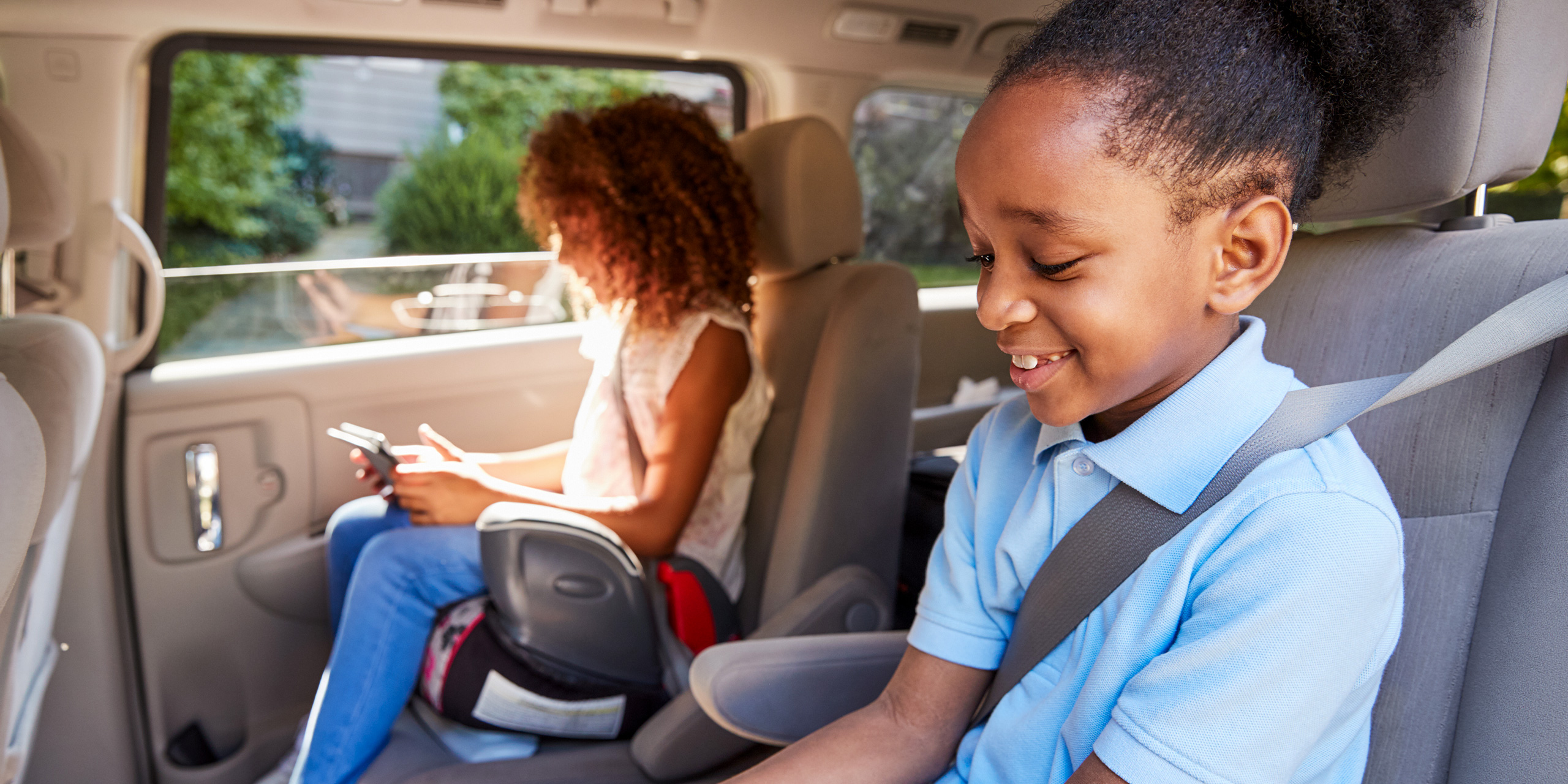 children in car using booster seat