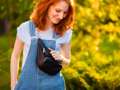 red-haired girl with waist bag in the Park